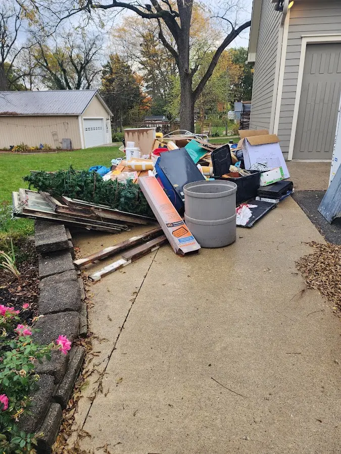 Dumpster being loaded with debris for Demolition Dumpster Rental in Freeland